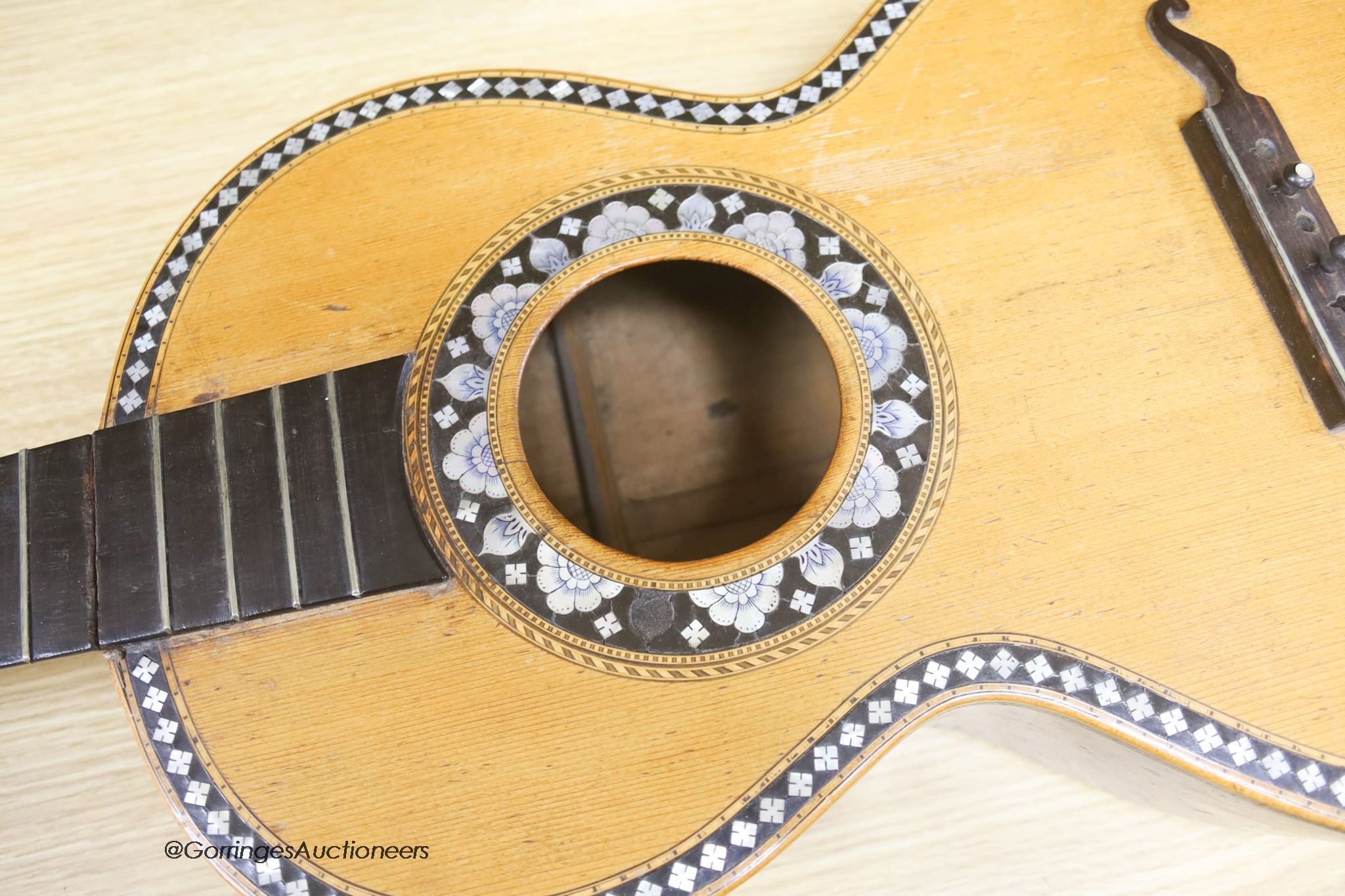 A Mexican mother of pearl inlaid acoustic guitar (no strings)